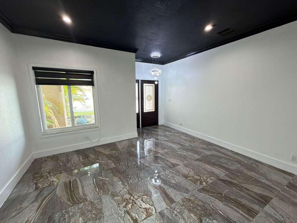 4572 Southwest 14th Street Deerfield Beach, FL 33442 - Photo 8 of 81 a view of an empty room with wooden floor and a window