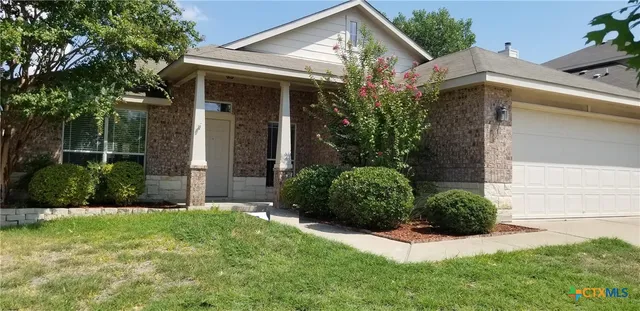a view of a house with a yard and plants