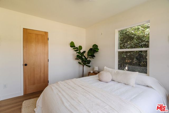 a bedroom with a bed and a window