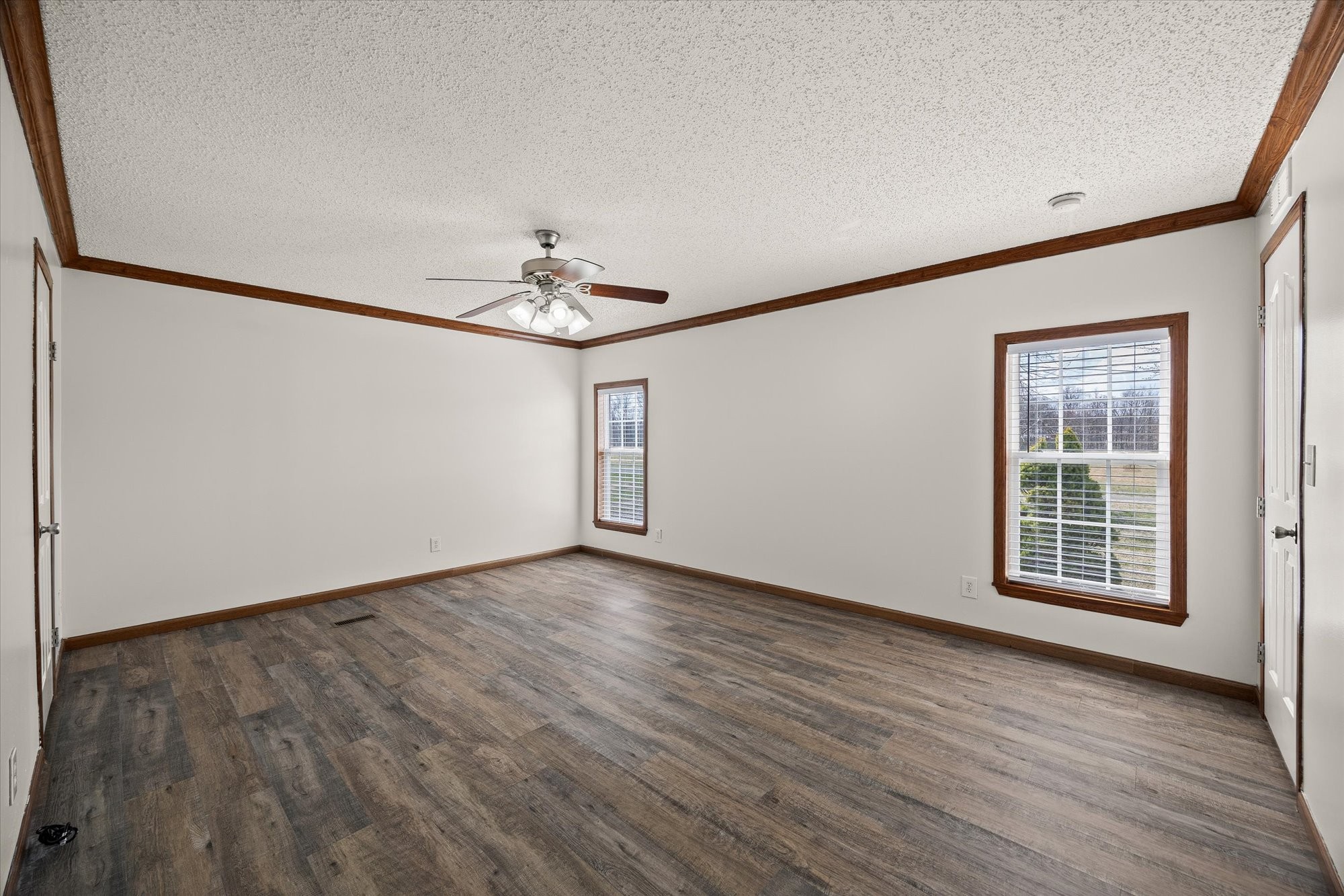 8533 Chaffin Road Baxter, TN 38544 - Photo 14 of 24 a view of an empty room with wooden floor and a window