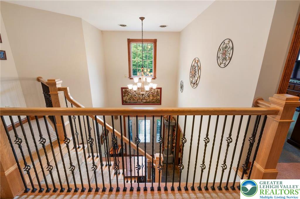 1222 Spring Road Andreas, PA 18211 - Photo 18 of 44 An open staircase with custom wood
handrails overlooks the airy entry
foyer below.