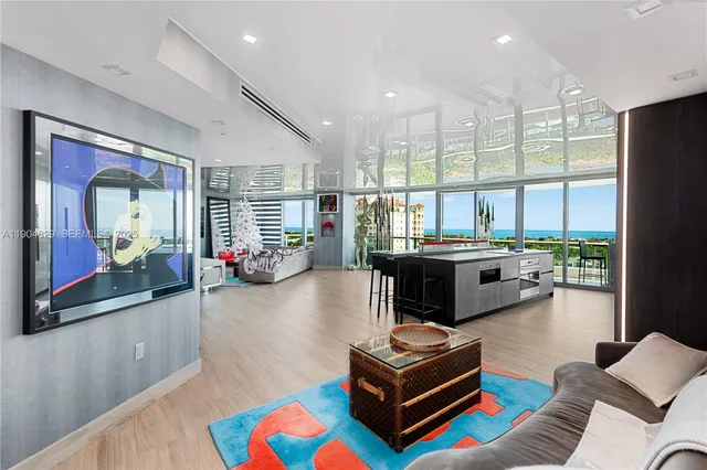 a living room with furniture a rug and a large window
