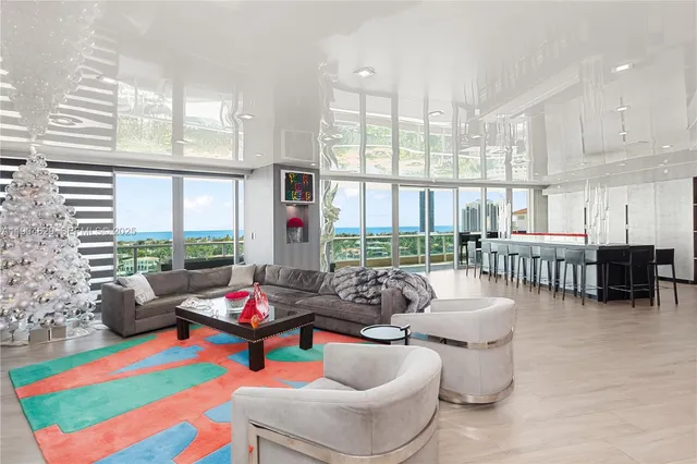 a living room with furniture and a floor to ceiling window