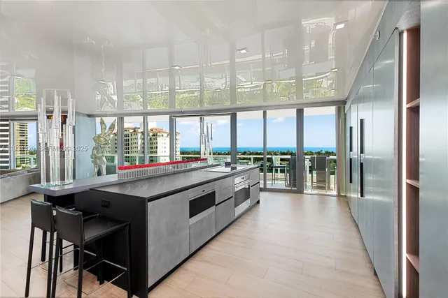 a kitchen with stainless steel appliances a large window and kitchen view