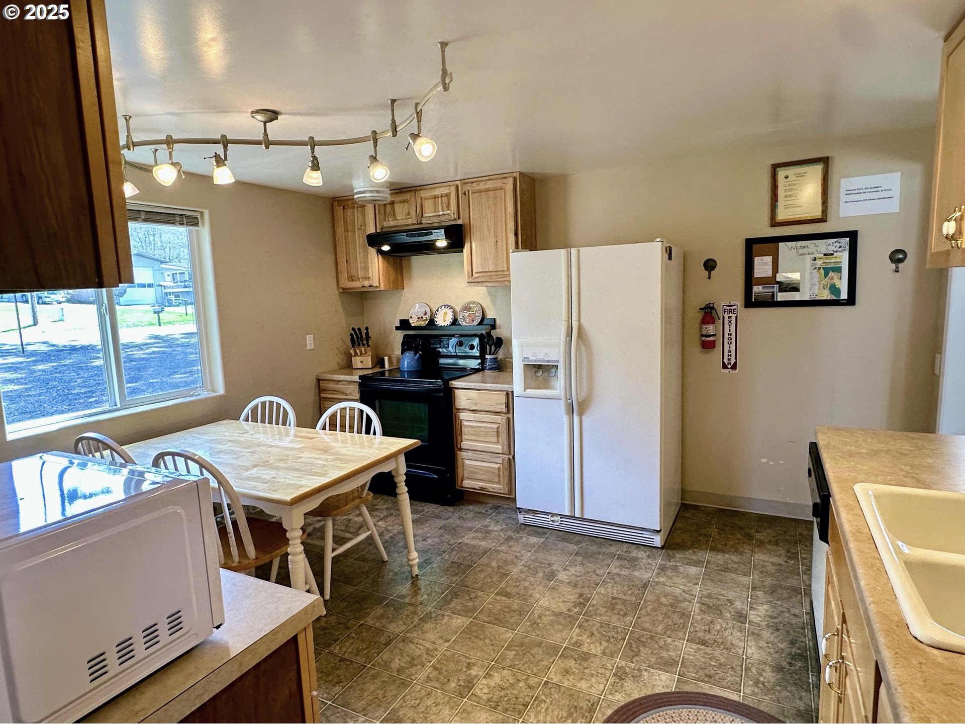 26230 Sandlake Road Cloverdale, OR 97112 - Photo 14 of 44 a kitchen with a refrigerator and a stove top oven