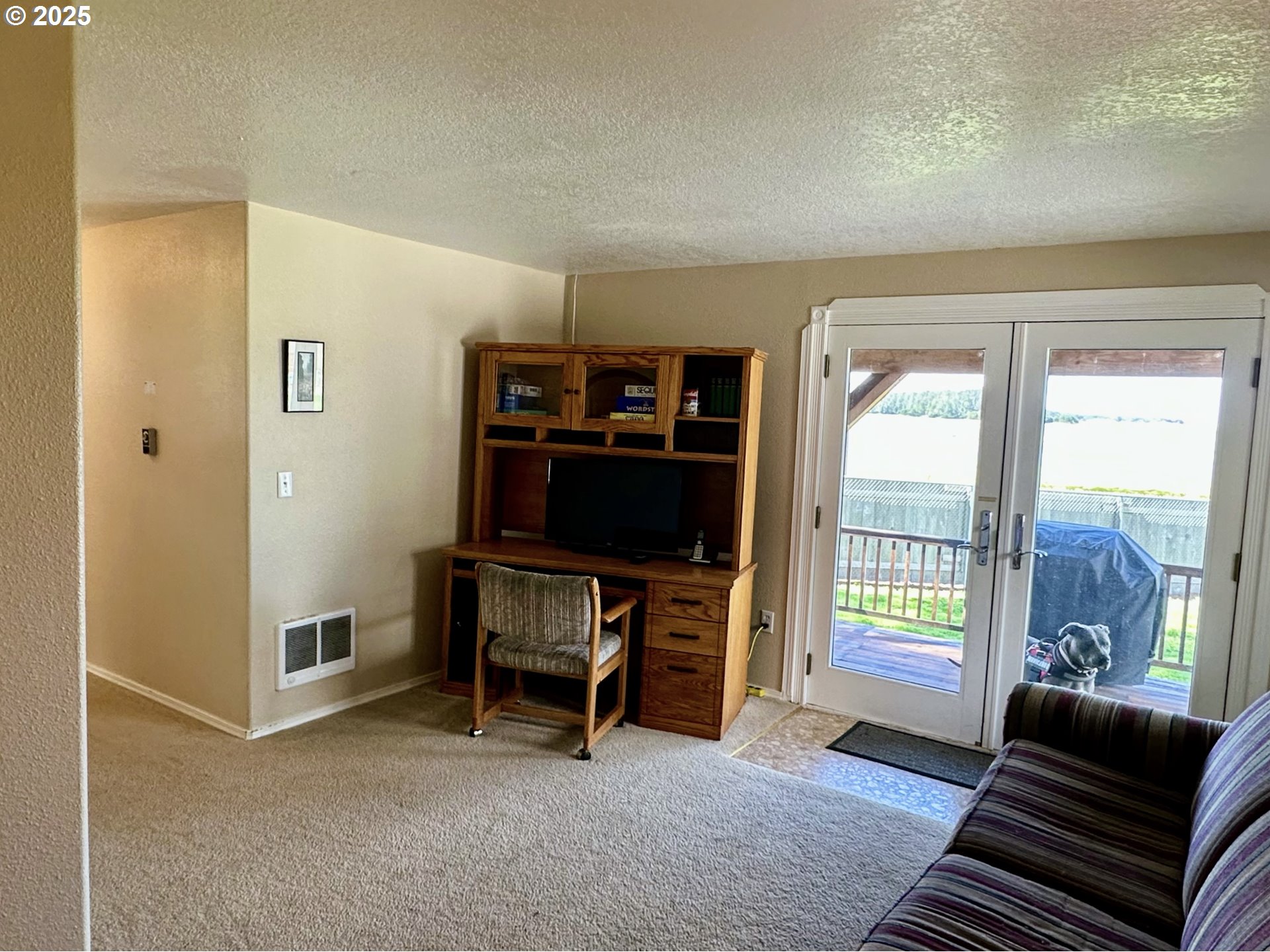 26230 Sandlake Road Cloverdale, OR 97112 - Photo 16 of 44 a living room with furniture and a flat screen tv