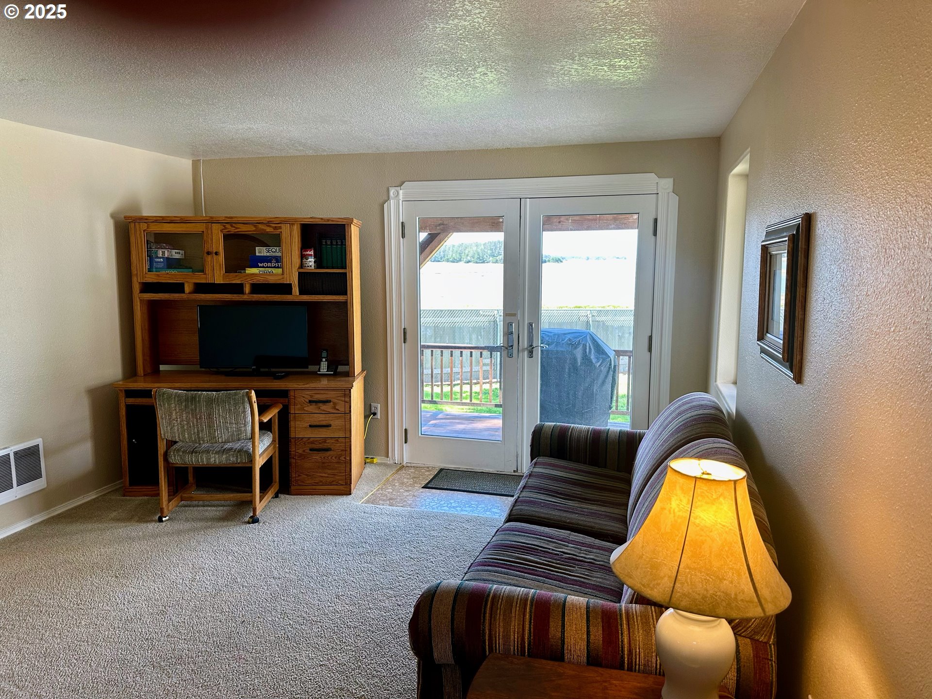 26230 Sandlake Road Cloverdale, OR 97112 - Photo 17 of 44 a living room with furniture and a flat screen tv