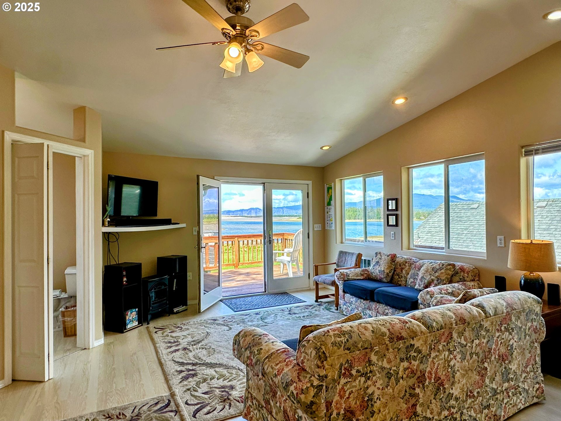 26230 Sandlake Road Cloverdale, OR 97112 - Photo 20 of 44 a living room with furniture a flat screen tv and a fireplace
