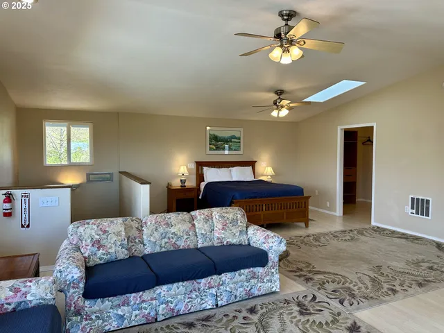 a bedroom with a large bed and a chandelier