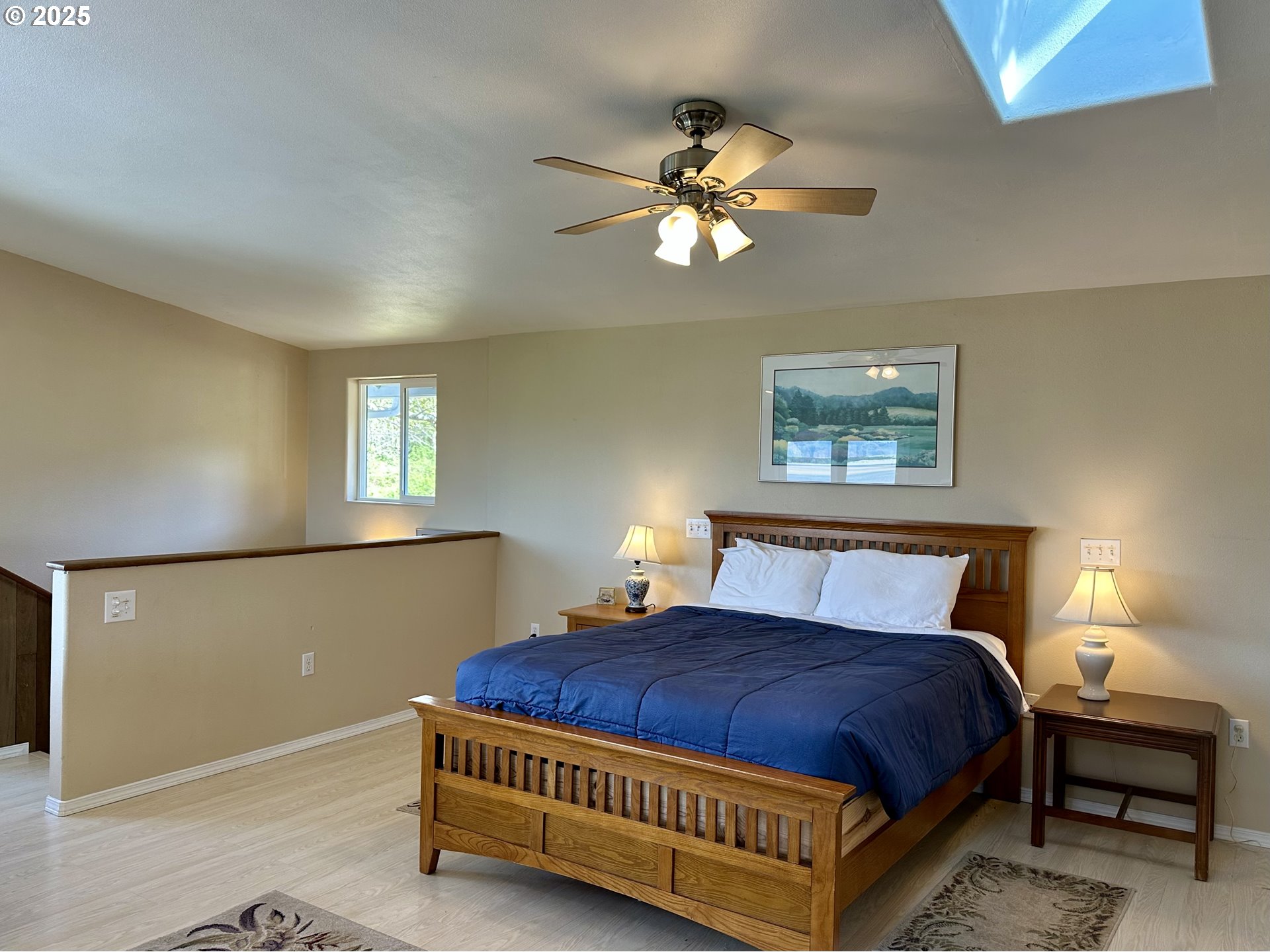26230 Sandlake Road Cloverdale, OR 97112 - Photo 23 of 44 a spacious bedroom with a bed and window