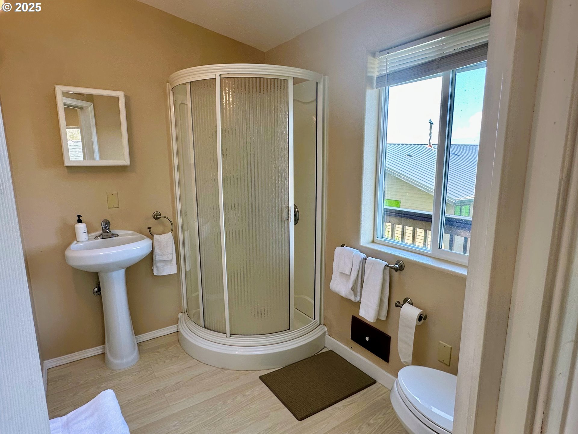 26230 Sandlake Road Cloverdale, OR 97112 - Photo 26 of 44 a bathroom with a sink toilet and shower