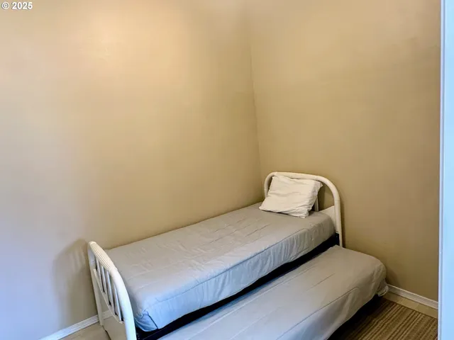 a bedroom with a bed and chair