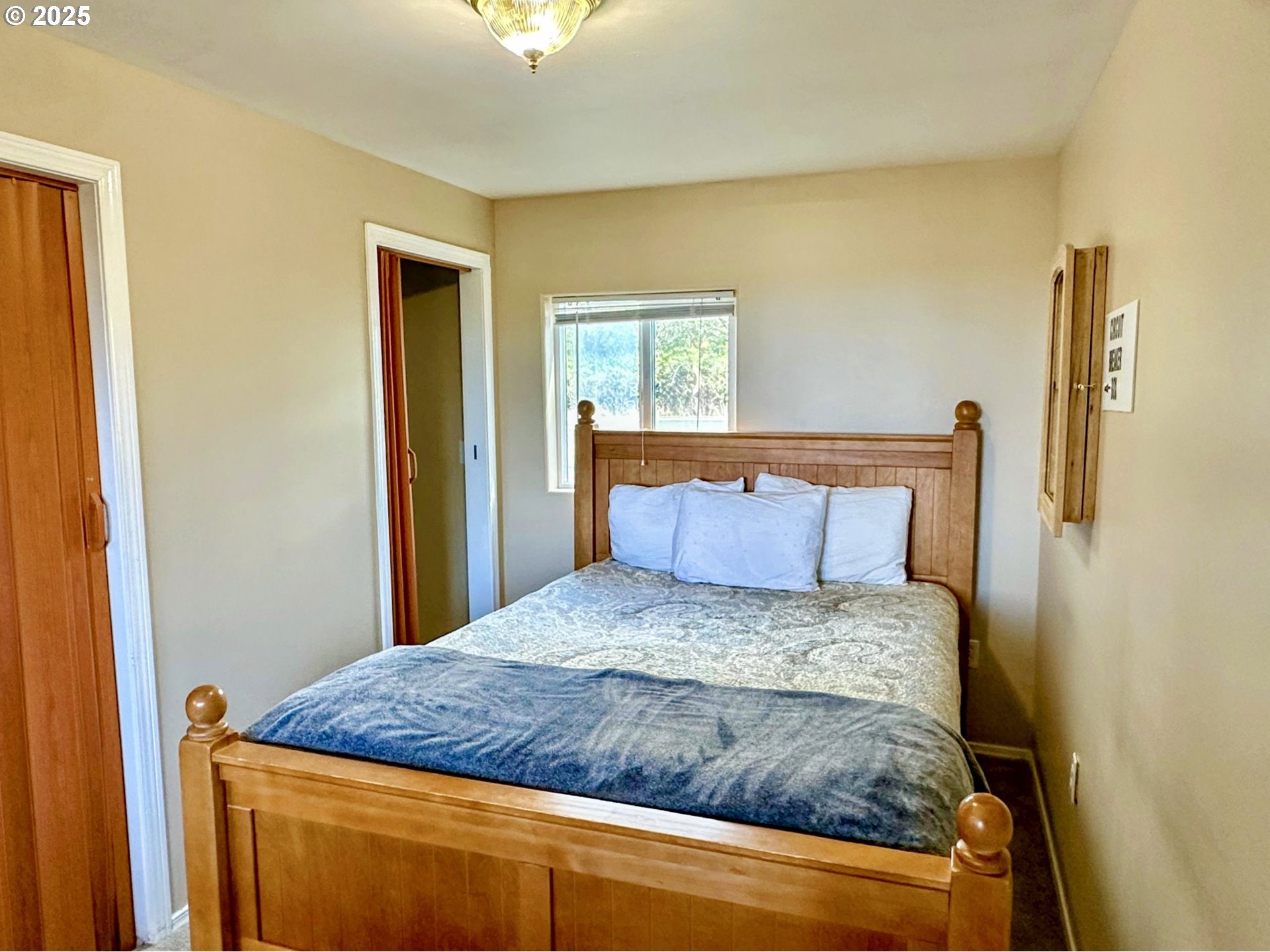 26230 Sandlake Road Cloverdale, OR 97112 - Photo 7 of 44 a bedroom with a bed and a dresser with wooden floor