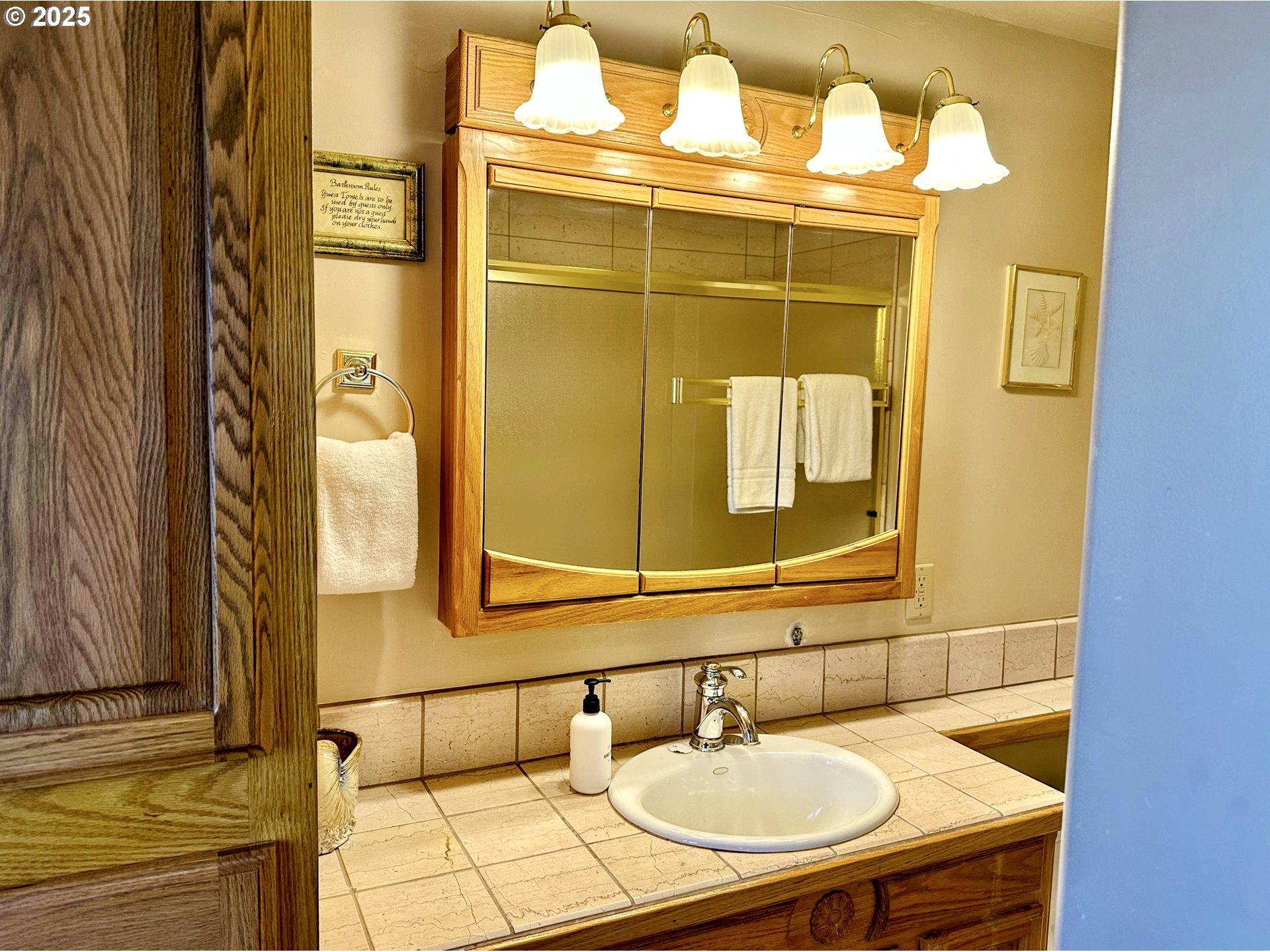 26230 Sandlake Road Cloverdale, OR 97112 - Photo 10 of 44 a bathroom with a sink and a mirror
