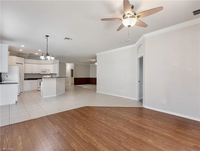 a view of a kitchen with wooden floor and a kitchen