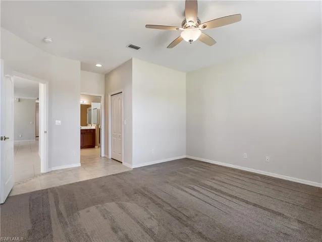 wooden floor in an empty room with a ceiling fan