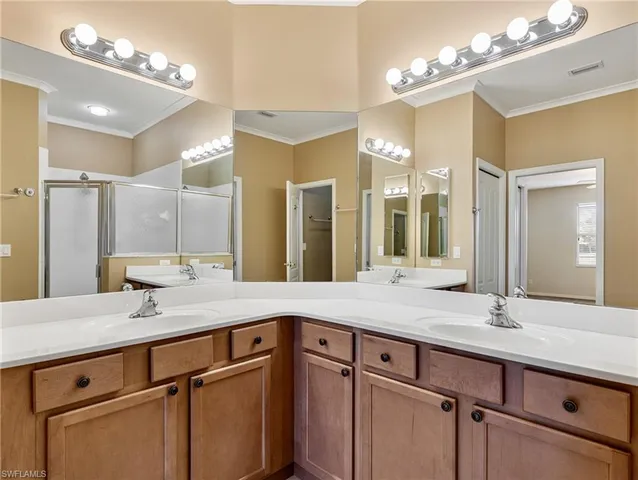 a bathroom with a sink double vanity and a mirror