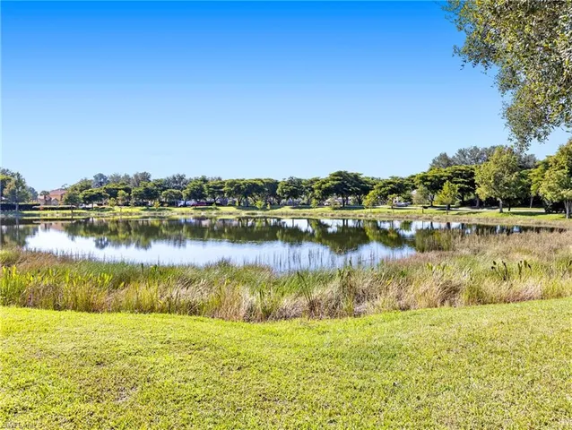 a view of a lake with houses in the background