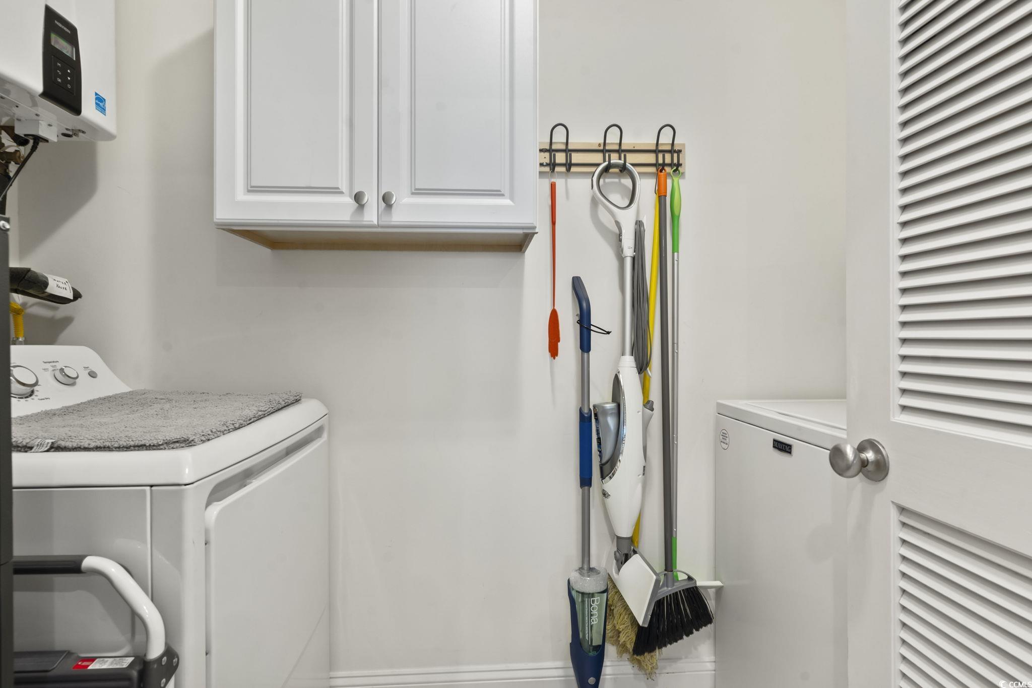 924 Jackline Place, Unit 201 Murrells Inlet, SC 29576 - Photo 11 of 35 Laundry room with cabinet space and water heater
