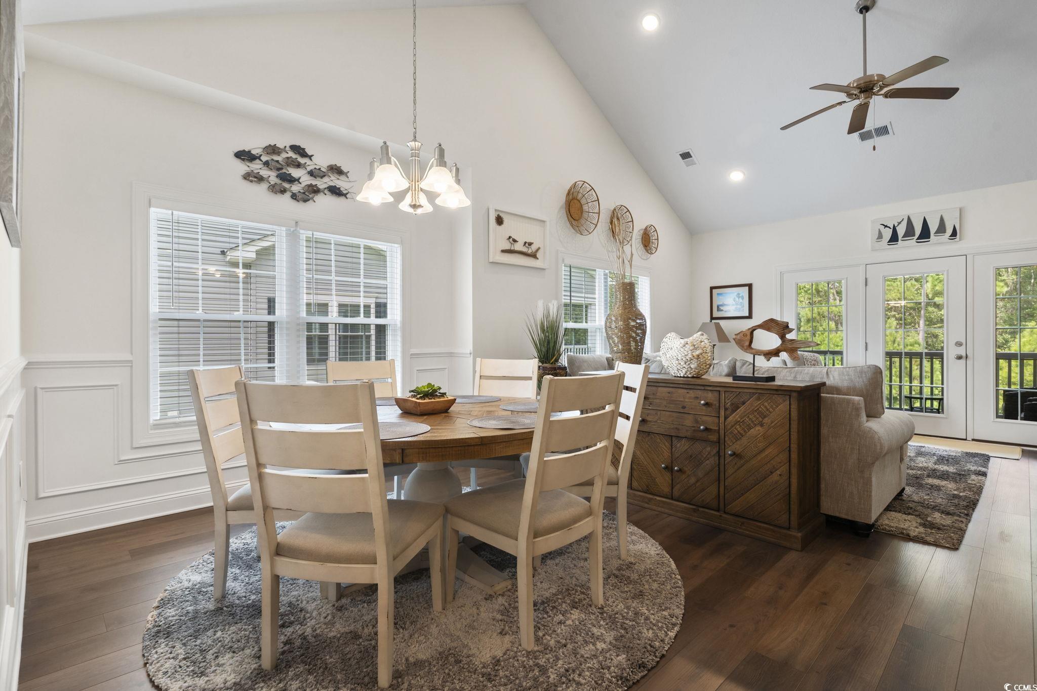 924 Jackline Place, Unit 201 Murrells Inlet, SC 29576 - Photo 12 of 35 Dining area with high vaulted ceiling, recessed lighting, dark wood-type flooring, a decorative wall, and a ceiling fan