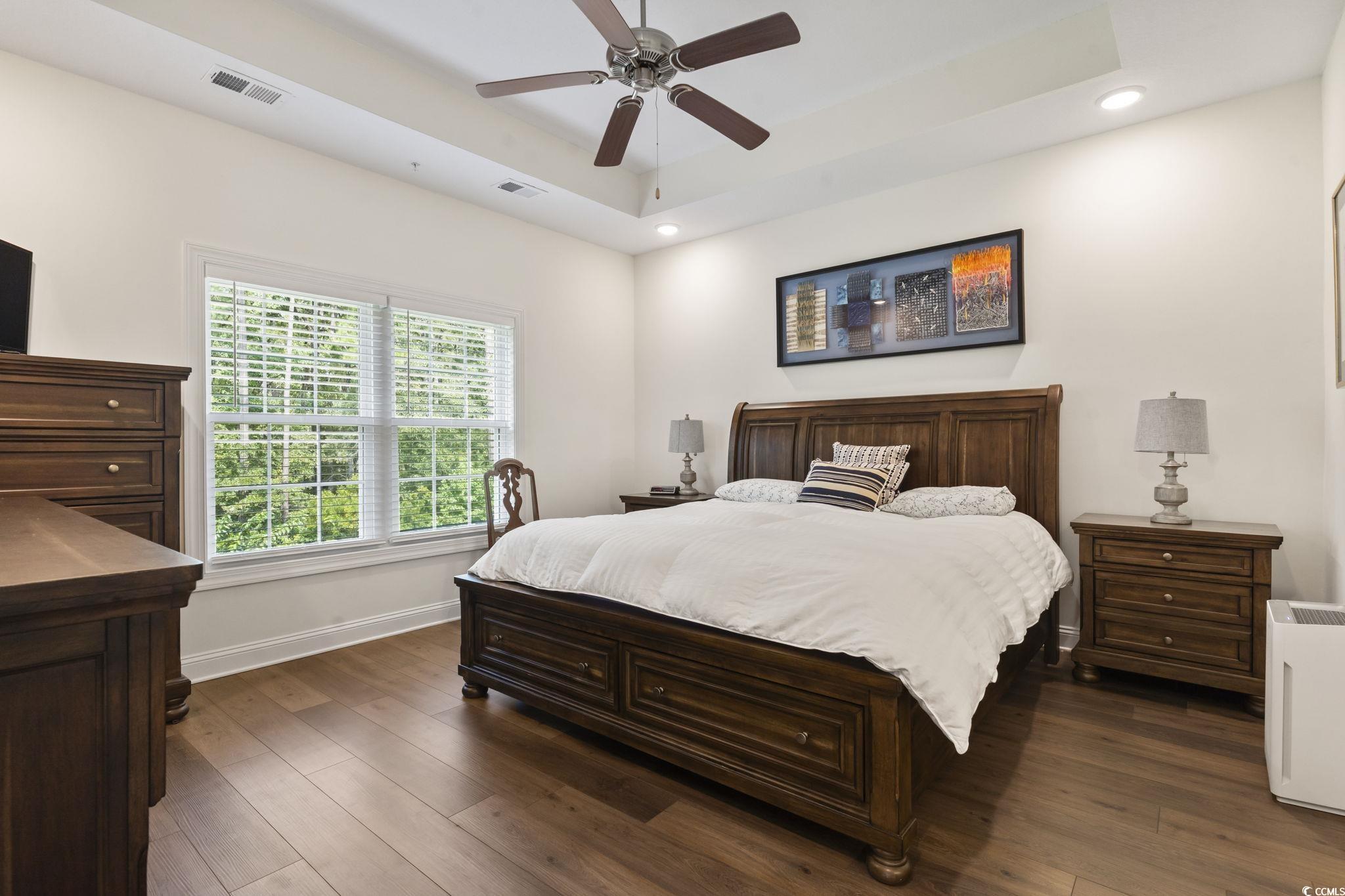924 Jackline Place, Unit 201 Murrells Inlet, SC 29576 - Photo 24 of 35 Bedroom featuring a raised ceiling, dark wood-style flooring, ceiling fan, and recessed lighting