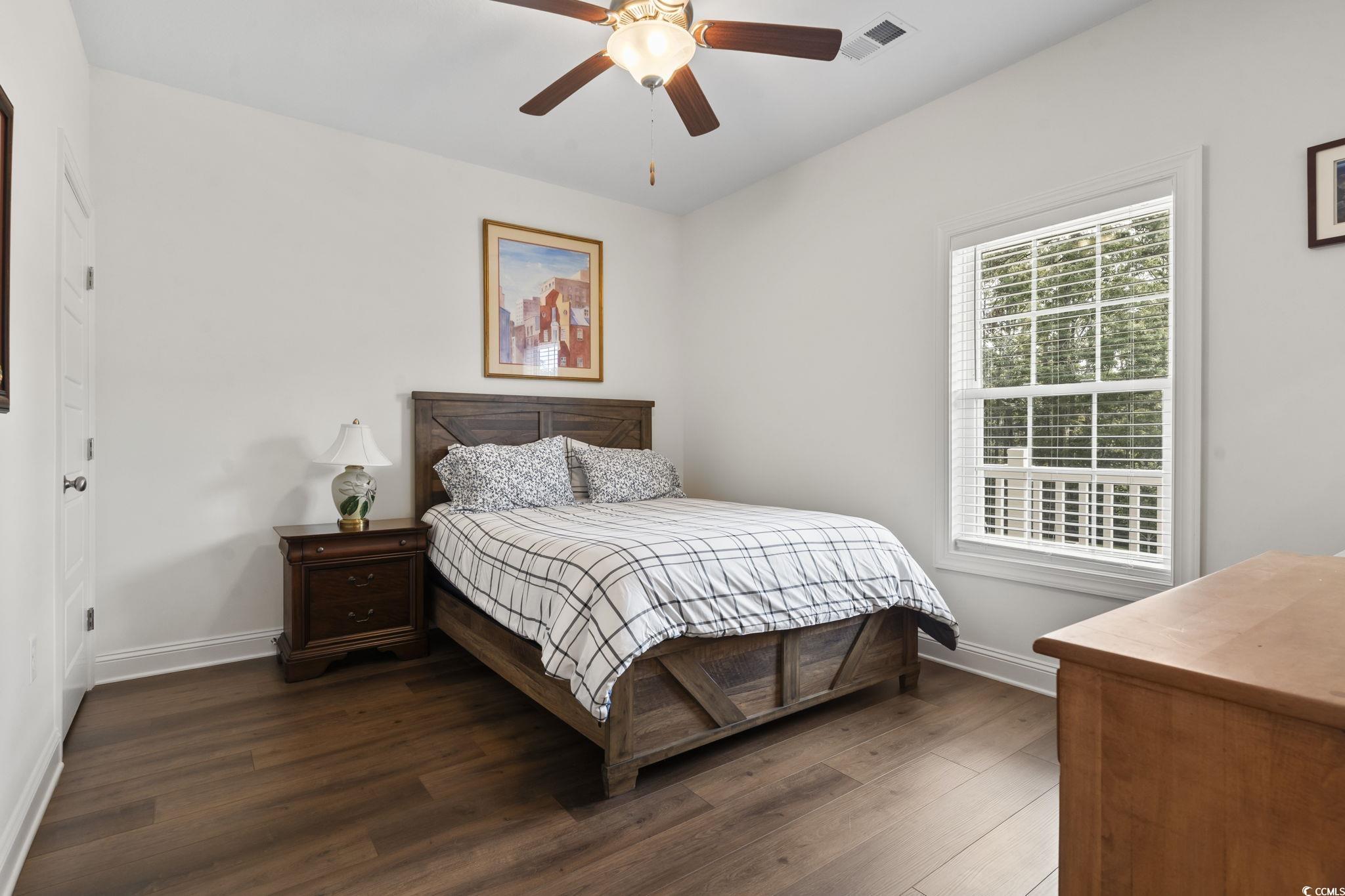 924 Jackline Place, Unit 201 Murrells Inlet, SC 29576 - Photo 25 of 35 Bedroom featuring dark wood-style floors and a ceiling fan
