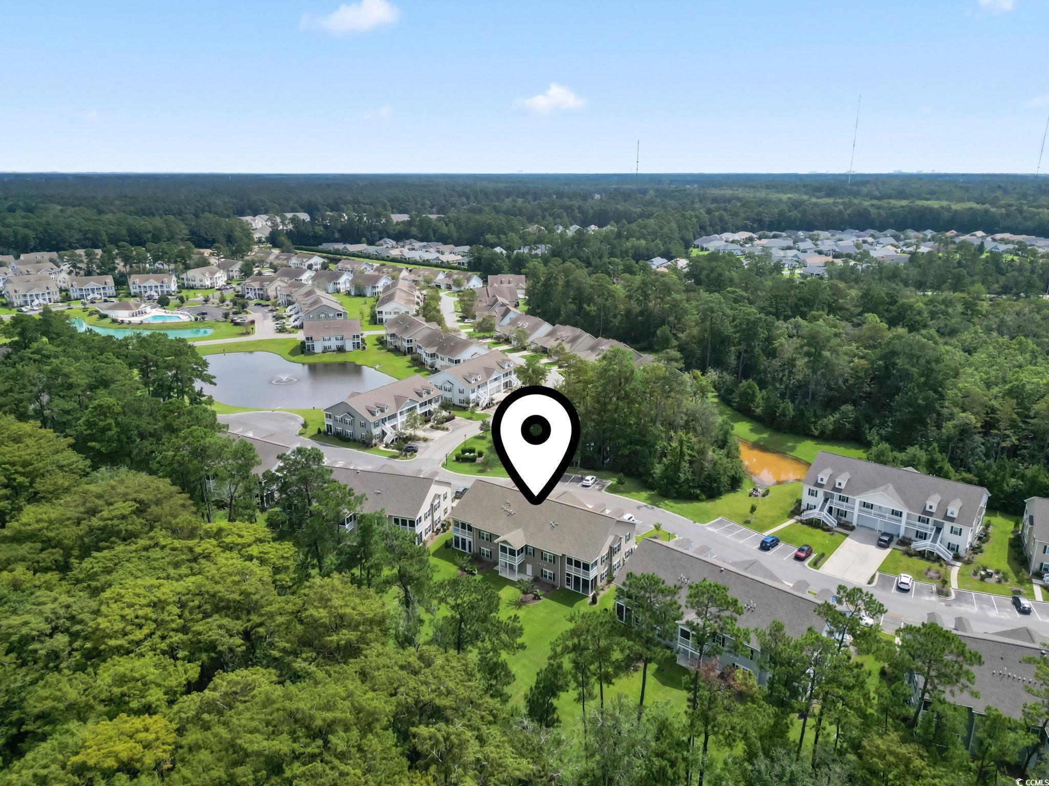 924 Jackline Place, Unit 201 Murrells Inlet, SC 29576 - Photo 33 of 35 Aerial view of residential area with a large body of water and a forest