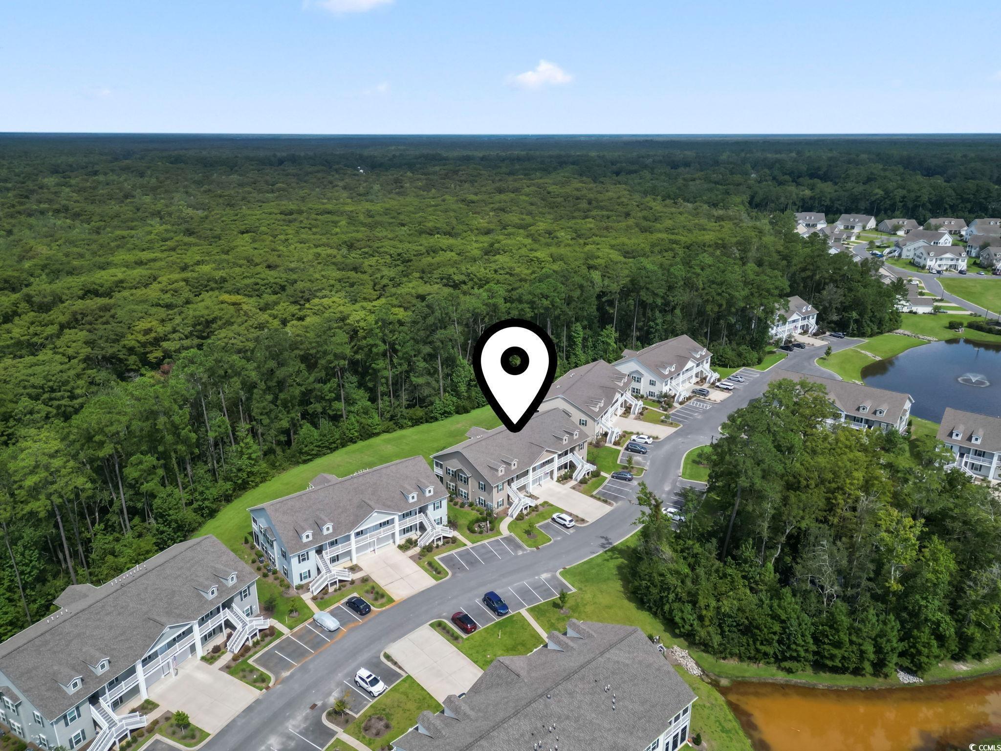 924 Jackline Place, Unit 201 Murrells Inlet, SC 29576 - Photo 34 of 35 View of property location with a heavily wooded area and nearby suburban area