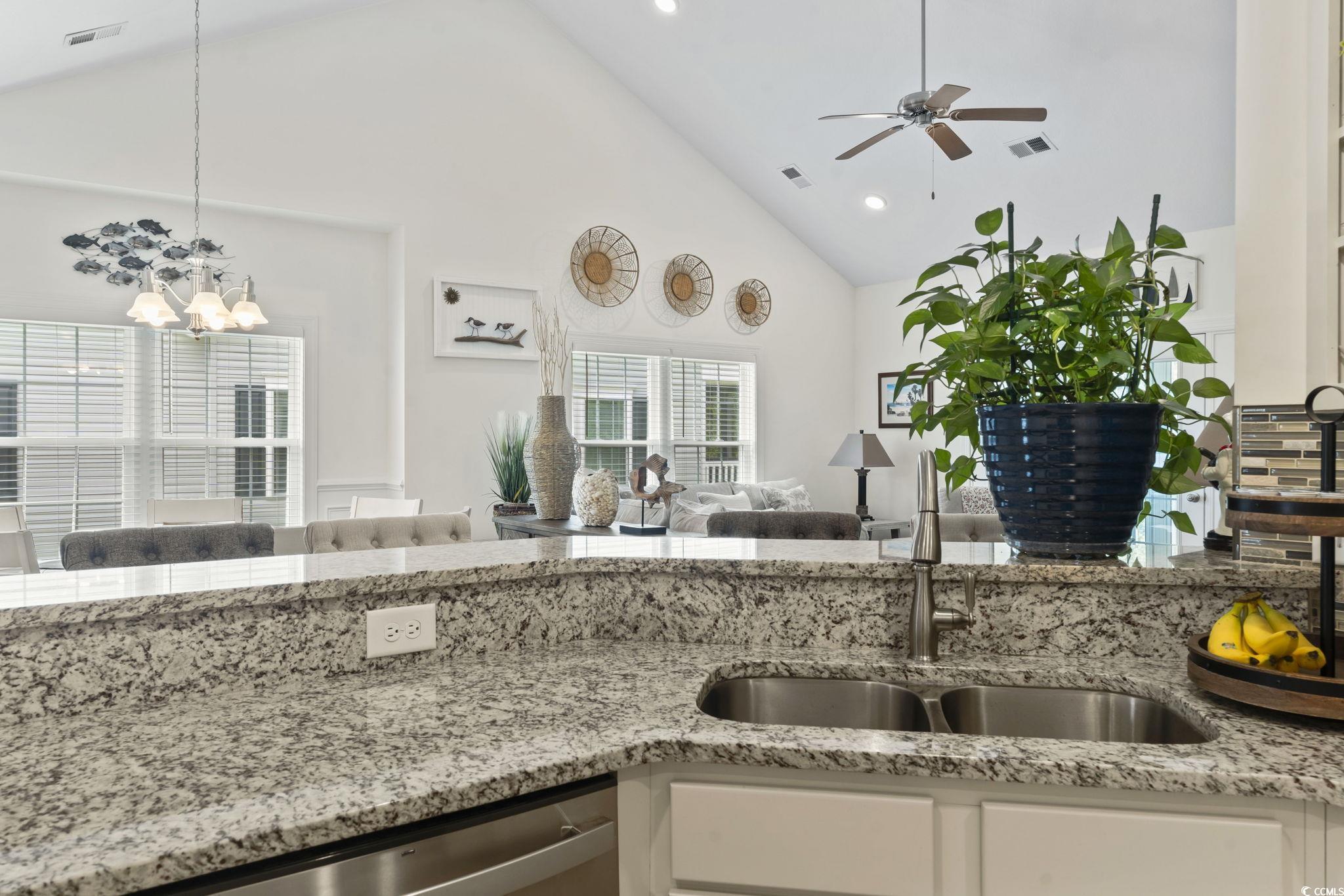 924 Jackline Place, Unit 201 Murrells Inlet, SC 29576 - Photo 35 of 35 Kitchen featuring light stone counters, high vaulted ceiling, open floor plan, white cabinetry, and decorative light fixtures