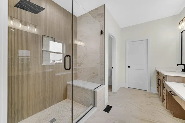 a bathroom with a shower and a sink