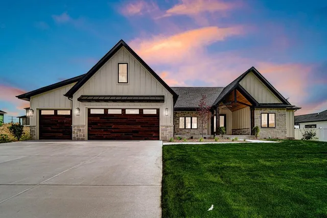 a front view of a house with a yard and garage