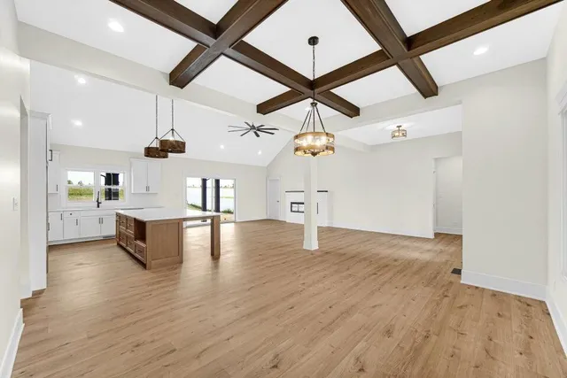 a view of kitchen and hall with wooden floor