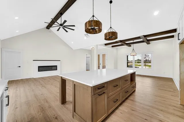 a kitchen with a stove and a wooden floor