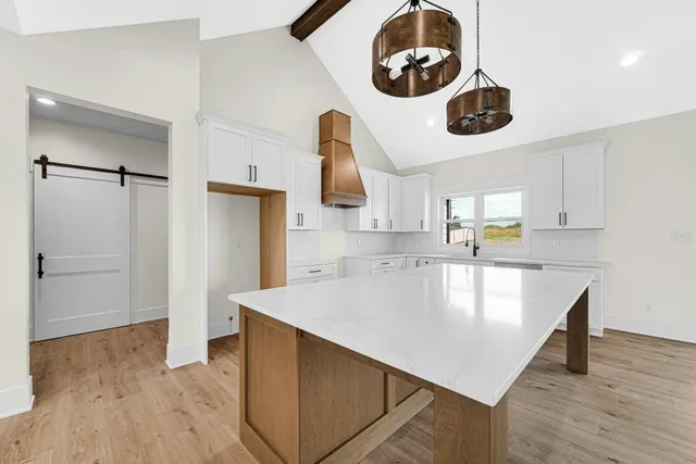 a kitchen with a wooden floor and chandelier