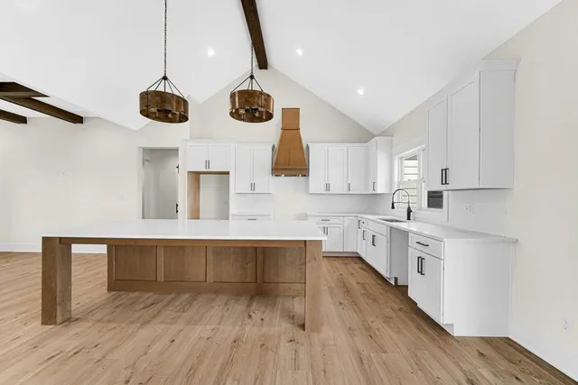 a large kitchen with lots of counter space wooden floor and appliances