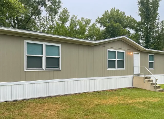 a view of a house with a backyard and a tree