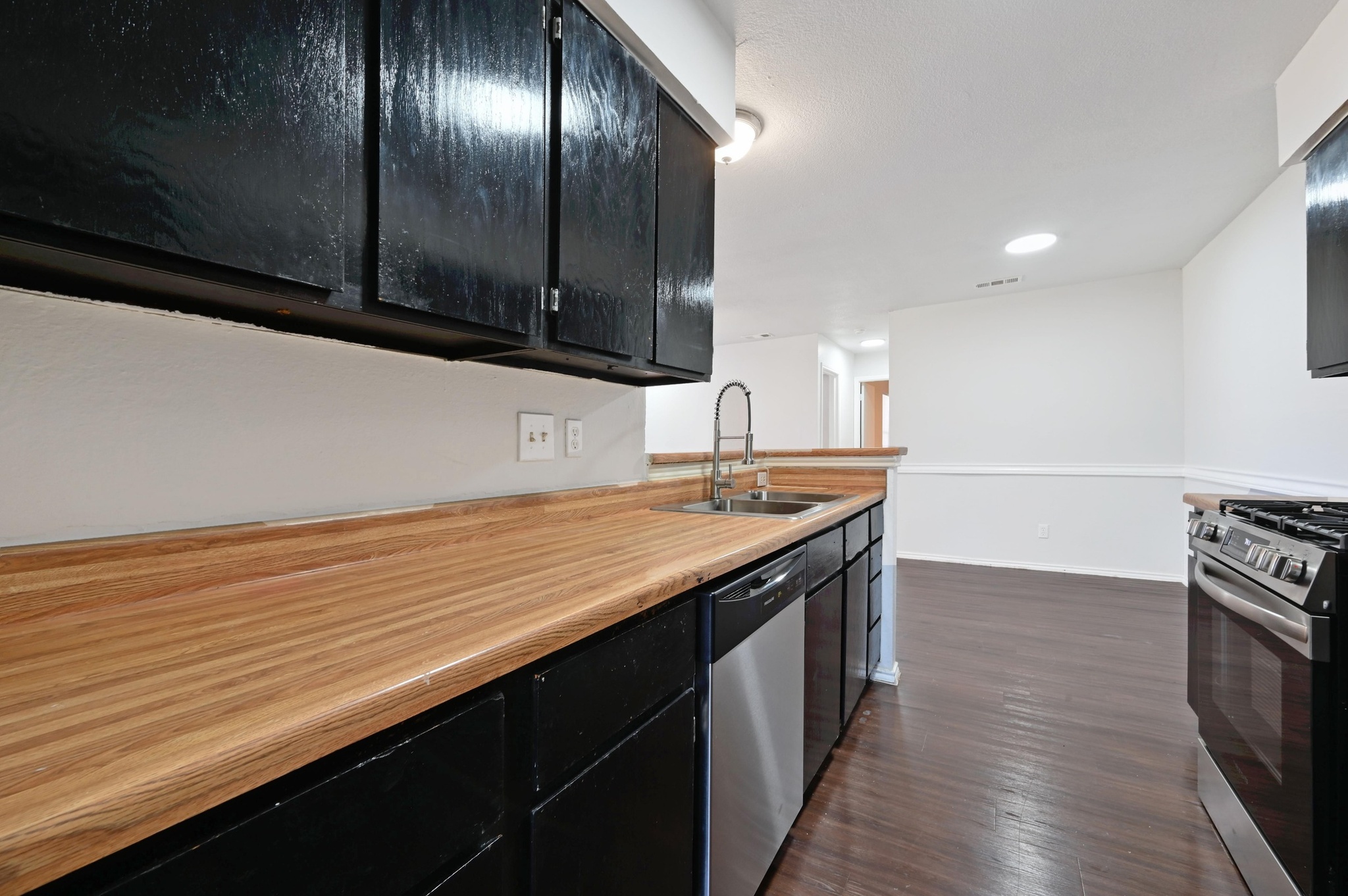5303 Spring Meadow Road Austin, TX 78744 - Photo 12 of 20 a kitchen with stainless steel appliances a sink and a stove