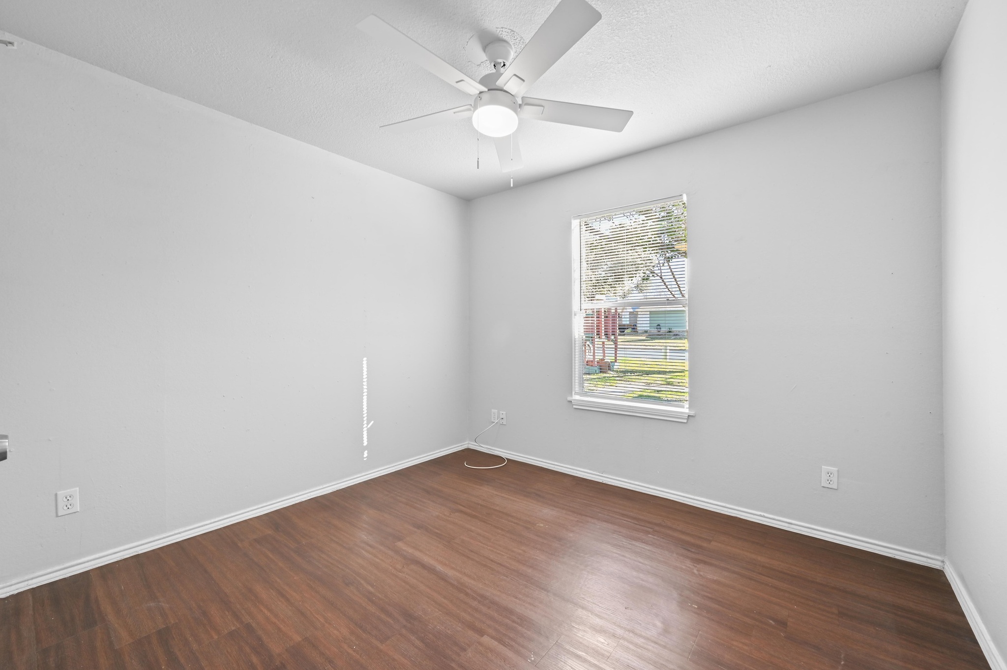 5303 Spring Meadow Road Austin, TX 78744 - Photo 16 of 20 an empty room with wooden floor and windows