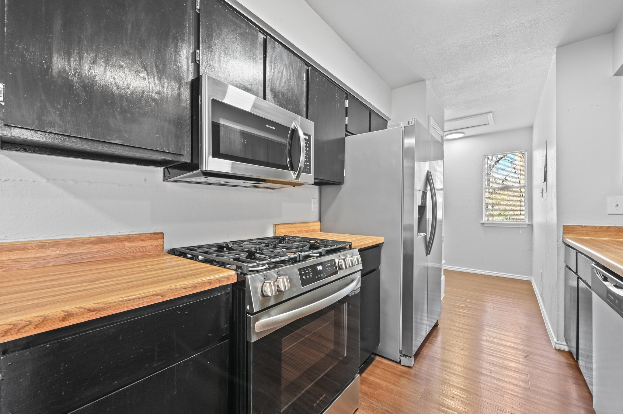 5303 Spring Meadow Road Austin, TX 78744 - Photo 10 of 20 a kitchen with stainless steel appliances granite countertop a stove and a refrigerator