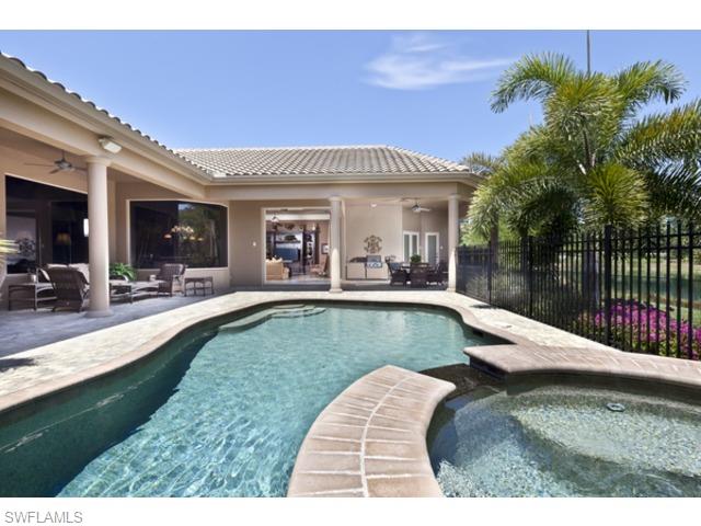 29031 Amarone Court Naples, FL 34110 - Photo 2 of 8 a view of a house with swimming pool and sitting area