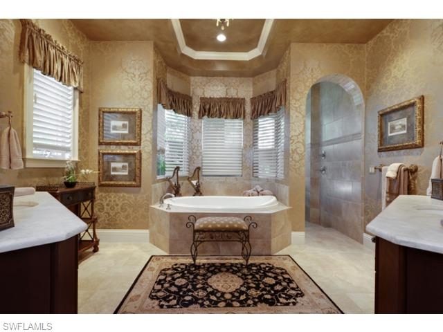 29031 Amarone Court Naples, FL 34110 - Photo 3 of 8 a living room with furniture a dining table and chairs