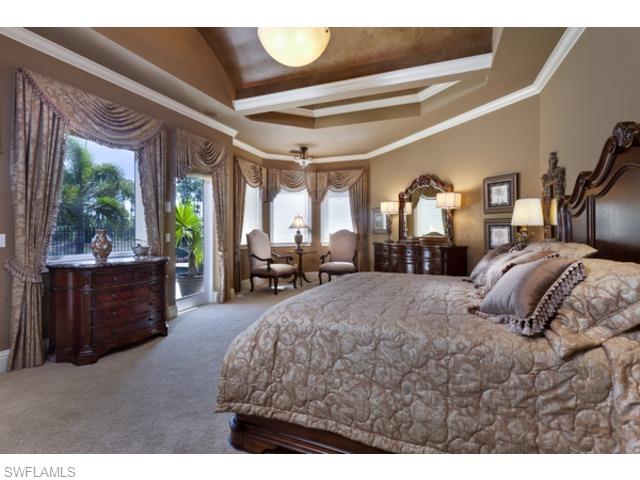 29031 Amarone Court Naples, FL 34110 - Photo 4 of 8 a bed room with a bed mirror and a balcony