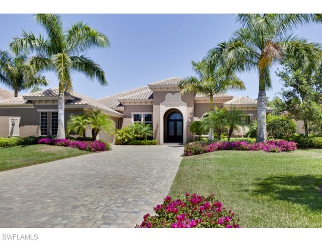 29031 Amarone Court Naples, FL 34110 - Photo 8 of 8 a front view of a house with a yard and garage