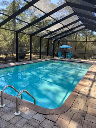 a view of a backyard with table and chairs