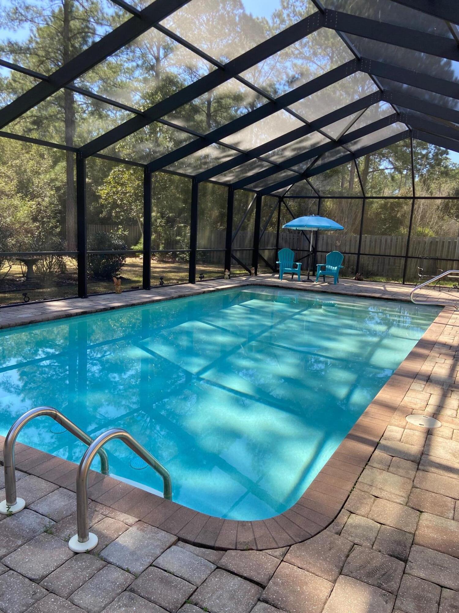 a view of a backyard with table and chairs