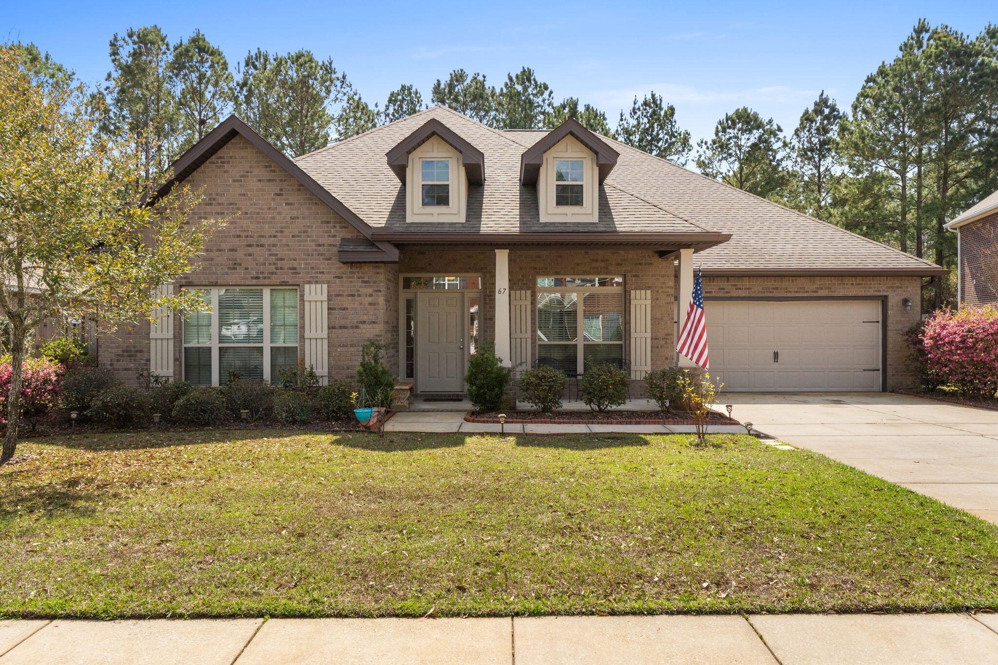67 Secret Street Freeport, FL 32439 - Photo 2 of 63 a front view of a house with a yard and garage