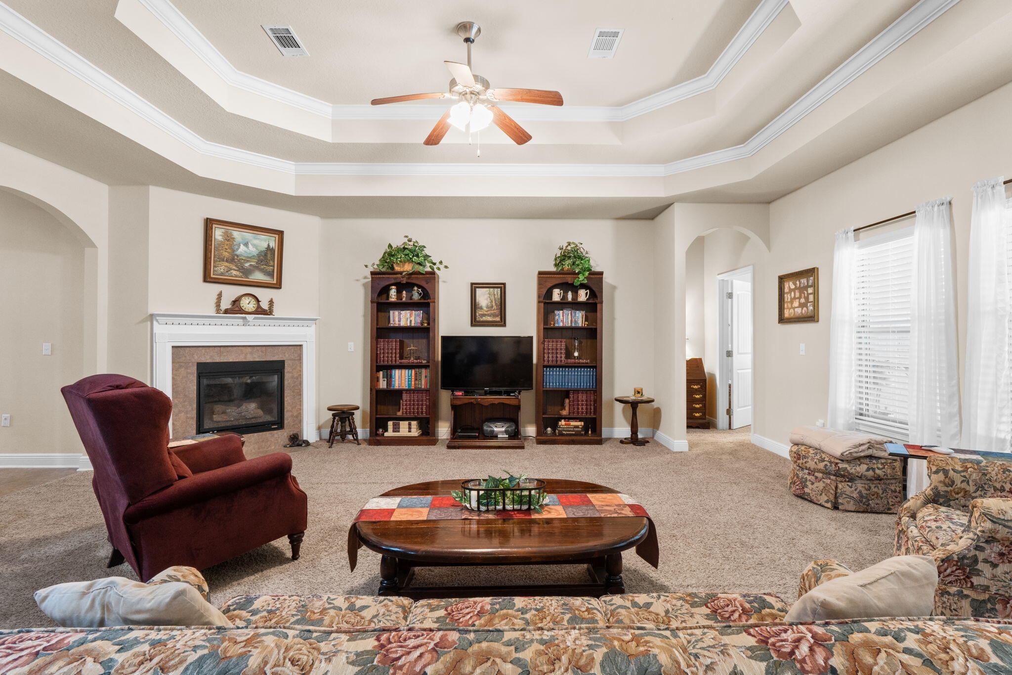 67 Secret Street Freeport, FL 32439 - Photo 25 of 63 a living room with furniture a fireplace and a chandelier