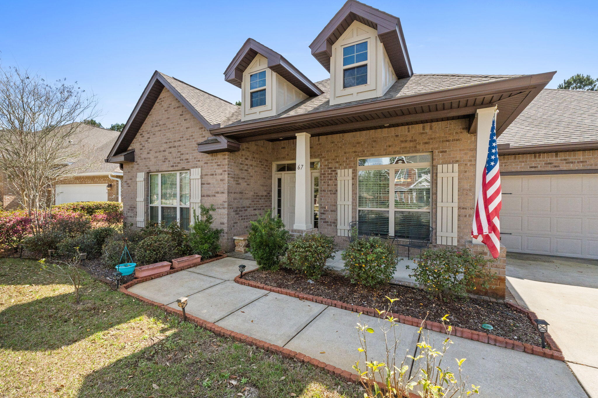 67 Secret Street Freeport, FL 32439 - Photo 3 of 63 a front view of a house with garden