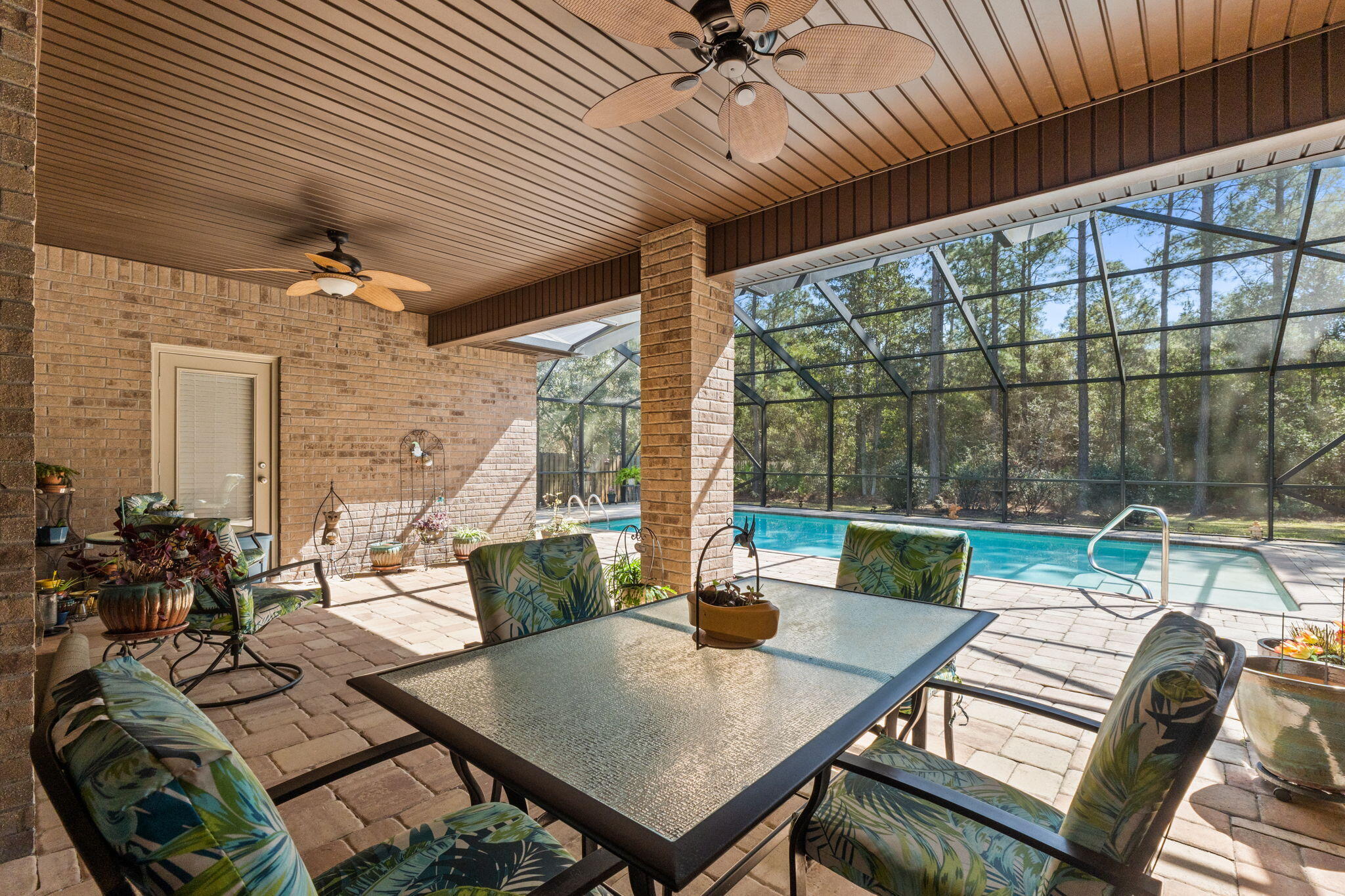 67 Secret Street Freeport, FL 32439 - Photo 48 of 63 a view of a patio with a dining table chairs and a potted plant