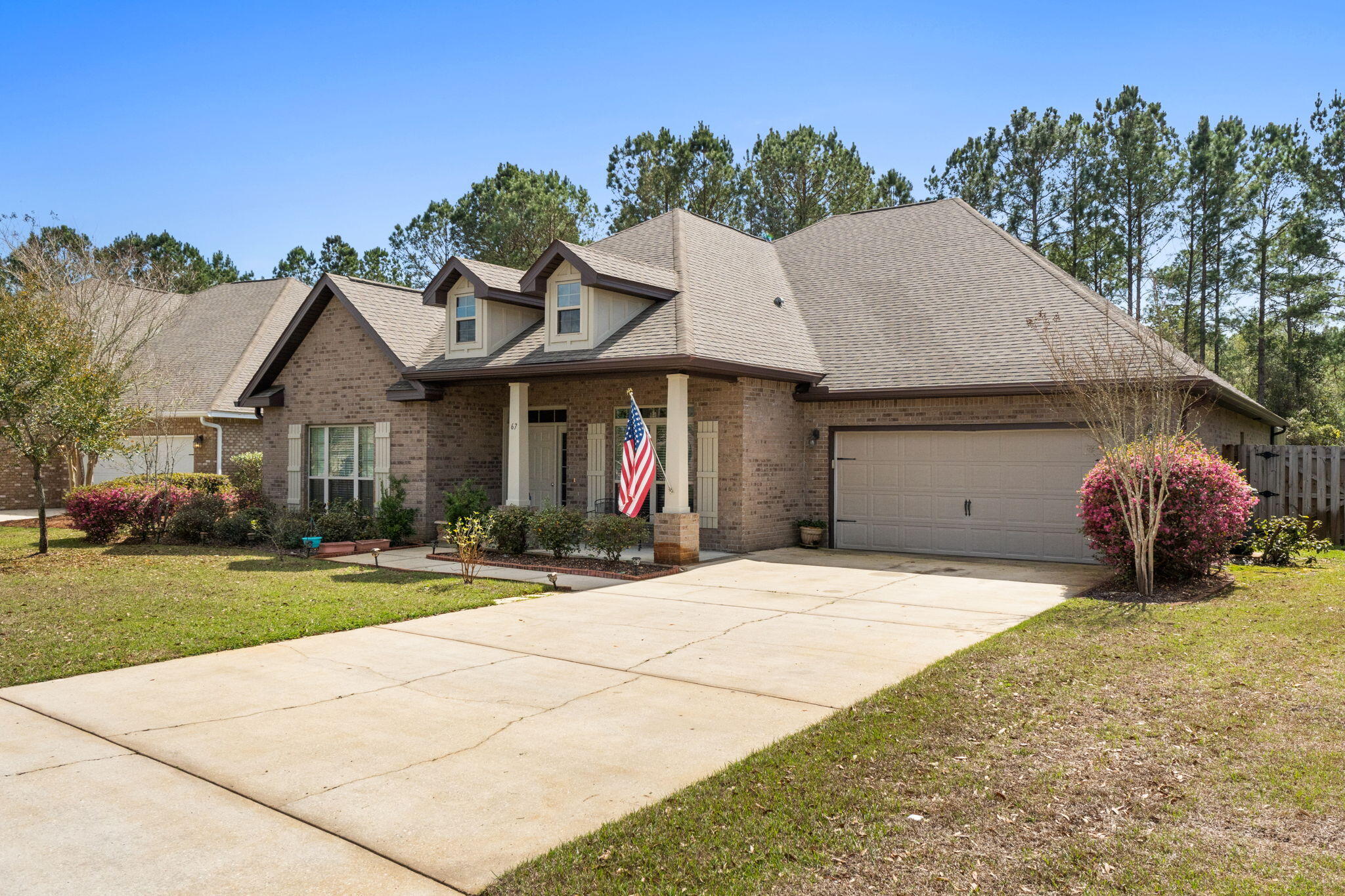 67 Secret Street Freeport, FL 32439 - Photo 5 of 63 a front view of a house with a yard and garage